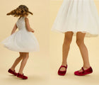 Split view of child dancing wearing Ten Little Velvet Ballet Flats - Burgundy Red. Available at www.tenlittle.com