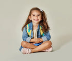Girl sitting wearing Ten Little Everyday Original - Blush Pink. Available at www.tenlittle.com