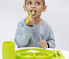 Child Eating Using Ezpz Happy Utensils Set of 3 in Lime - Available in www.tenlittle.com