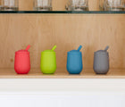 ezpz Mini Cup & Straw in blue and 3 other colors inside cabinet. Available at tenlittle.com
