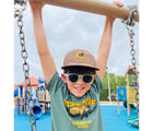 Boy wearing Roshambo Round Sunglasses - Sage Green. Available at www.tenlittle.com