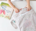 Child utilizing the Bumkins Wet/Dry Bag - Wander. Available from www.tenlittle.com