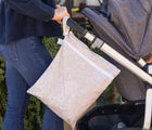 Bumkins Wet/Dry Bag - Wander attached to stroller. Available from www.tenlittle.com