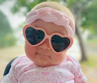 Baby wearing Ten Little Roshambo Heart Sunglasses - Pink. Available at www.tenlittle.com