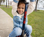 Child outside with Micro Kickboard Maxi Deluxe Foldable LED Scooter - Navy Blue/Red. Available at www.tenlittle.com