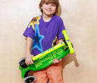 Child holding folded Micro Kickboard Maxi Deluxe Foldable LED Scooter - Neon Parrot Green. Available at www.tenlittle.com