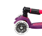 Close up of light-up wheel on Micro Kickboard Maxi Deluxe Foldable LED Scooter - Neon Ultra Pink. Available at www.tenlittle.com