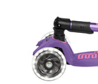Close up of light-up wheel on Micro Kickboard Maxi Deluxe Foldable LED Scooter - Purple. Available at www.tenlittle.com