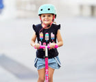 Child riding Micro Kickboard Maxi Deluxe Foldable LED Scooter - Shocking Pink. Available at www.tenlittle.com