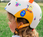 Side view of child wearing of Micro Kickboard Micro Helmet - Monster. Available at www.tenlittle.com