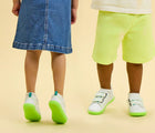Split view of children wearing Ten Little Everyday Original - Neon Glow - Neon Green. Available at www.tenlittle.com