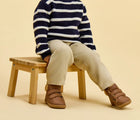 Child sitting wearing Ten Little Furry High Top - Chestnut Brown. Available at www.tenlittle.com