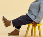 Child sitting wearing Ten Little Everyday High Top - Mocha Brown. Available at www.tenlittle.com