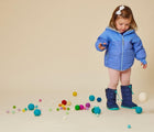 Baby wearing Ten Little Snow Boots in Navy and Teal. Available at www.tenlittle.com