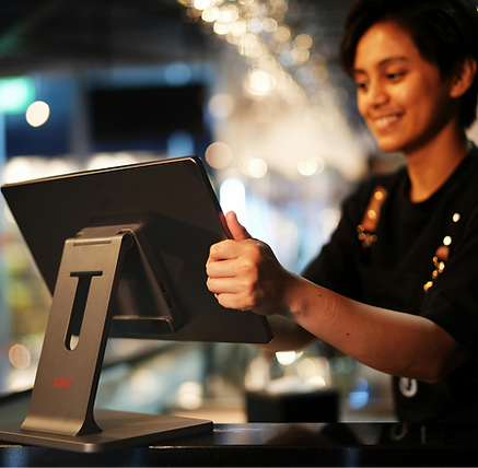 Restaurant staff viewing LineTen mobile order management interface on a tablet device in a low-light operational environment