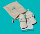 Front view of Ten Little Everyday Baby Booties with dust bag - Soft White. Available at www.tenlittle.com