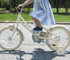 Child riding Banwood Classic Bike Cream. Available at www.tenlittle.com