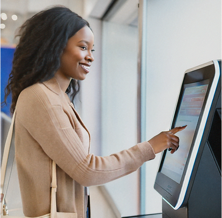 Customer interacting with a self-service LineTen kiosk, highlighting user-friendly ordering in a quick service restaurant.