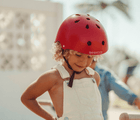 Child wearing Banwood Classic Helmet red - Available at www.tenlittle.com