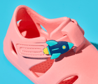 Close up of Ten Little Pink Lemonade Splash Sandals with Splash Sandal Charms 2 on - Rocket Ship. Available at www.tenlittle.com