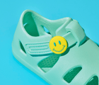Close up of Ten Little Aqua Mint Splash Sandals with Splash Sandal Charms 2 on - Smiley. Available at www.tenlittle.com